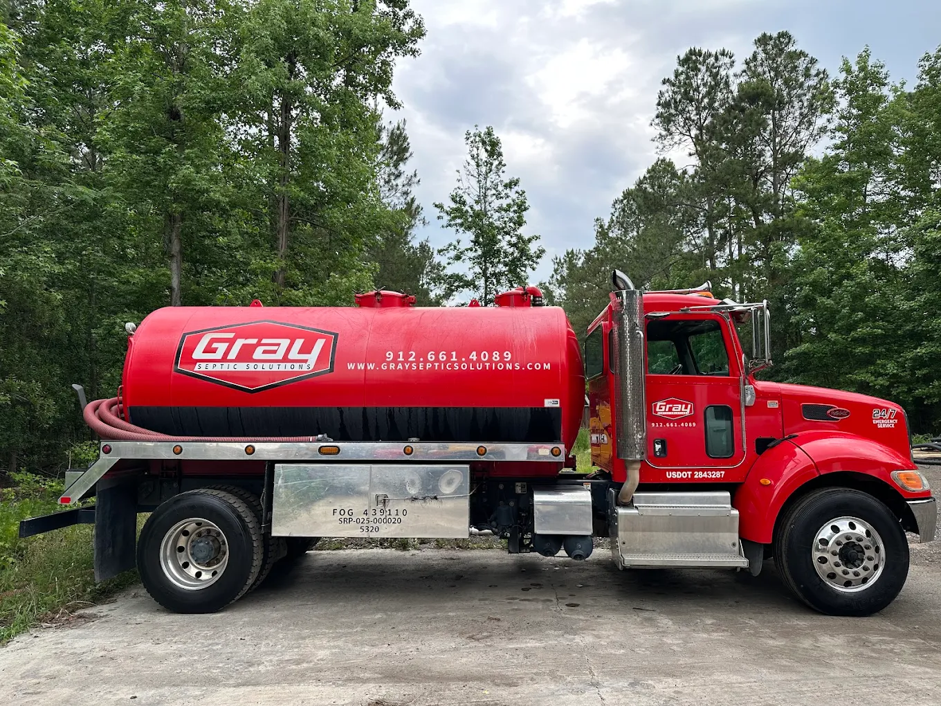 Gray Septic Solutions vacuum tanker truck pumping a septic tank