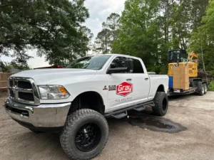 Gray Septic Solutions vacuum tanker truck pumping a septic tank