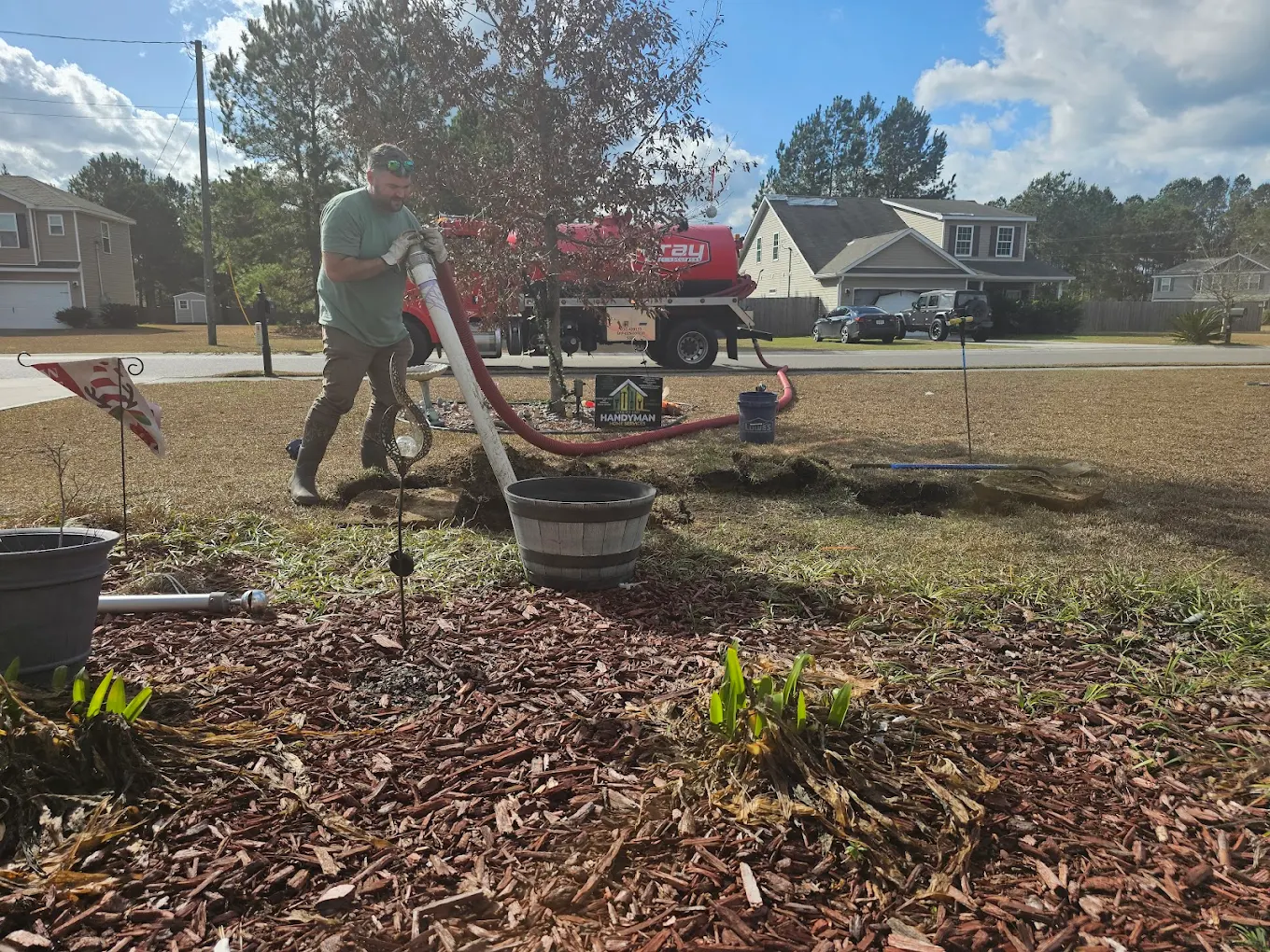 Technician installing a septic line in a residential yard