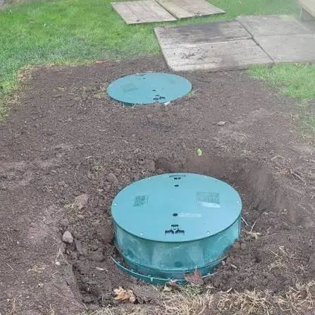 Installed green septic tank access riser and lid